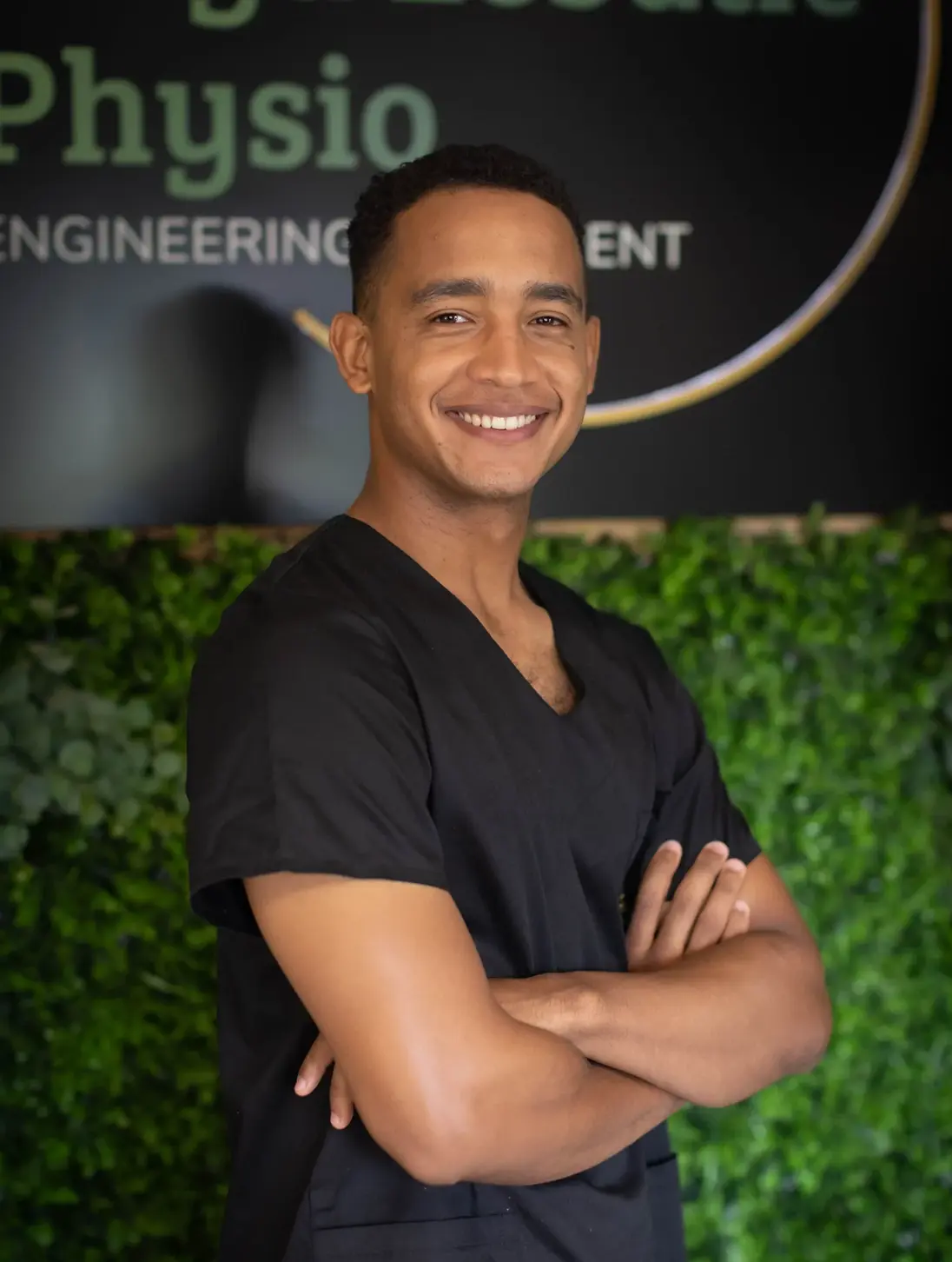 Meet Our Experts 3 Jamie Thomas, sports physiotherapist at Floyd Lebatie Physio, wearing black clinical scrubs